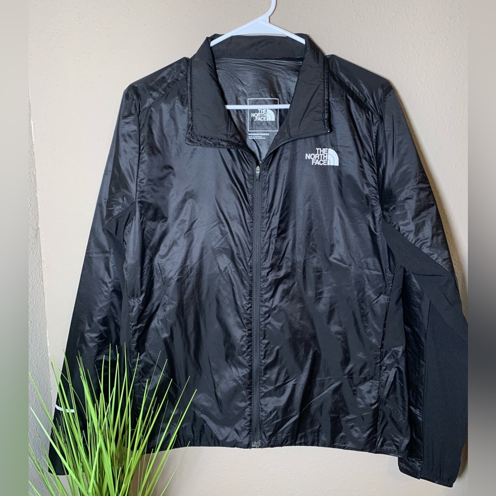 The North Face zip up black light weight jacket. Size L.